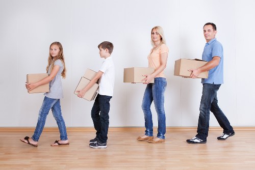 Packed boxes and furniture ready for a Barnes house removal service